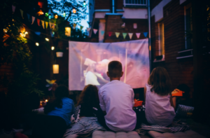 Kids watching movie outside