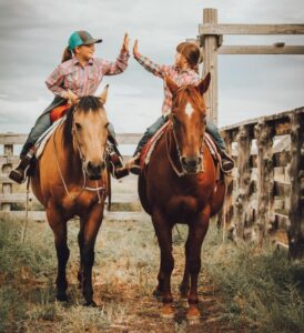 two young girls on horseback (photo contest)