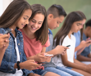 girls sitting on their phones