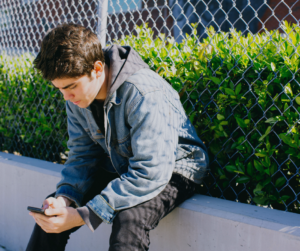 boy sitting on his phone