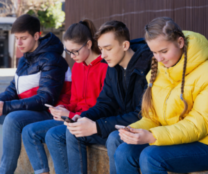 kids sitting on their phones