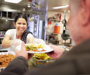 woman serving food at shelter