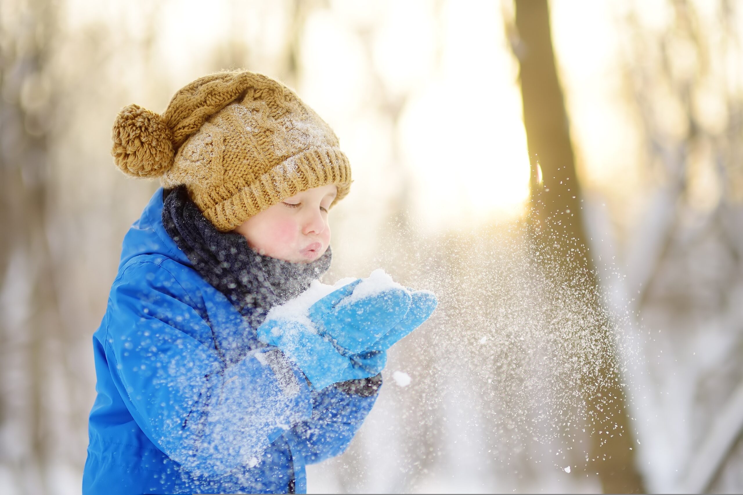 Little,Boy,Blowing,Snow,From,His,Hands 